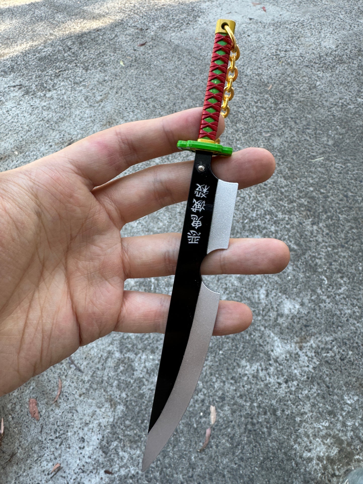 DEMON SLAYER – TENGEN UZUI’S NICHIRIN CLEAVER KEYCHAIN